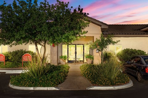 A building with a car parked in front of it.