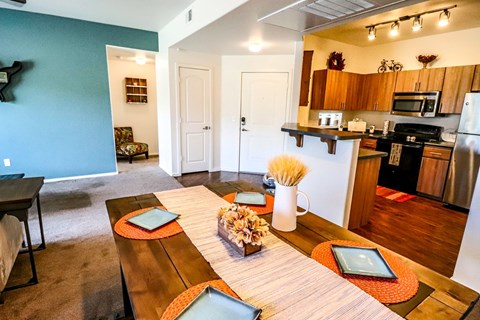 A kitchen with a table and chairs in the middle of the room.