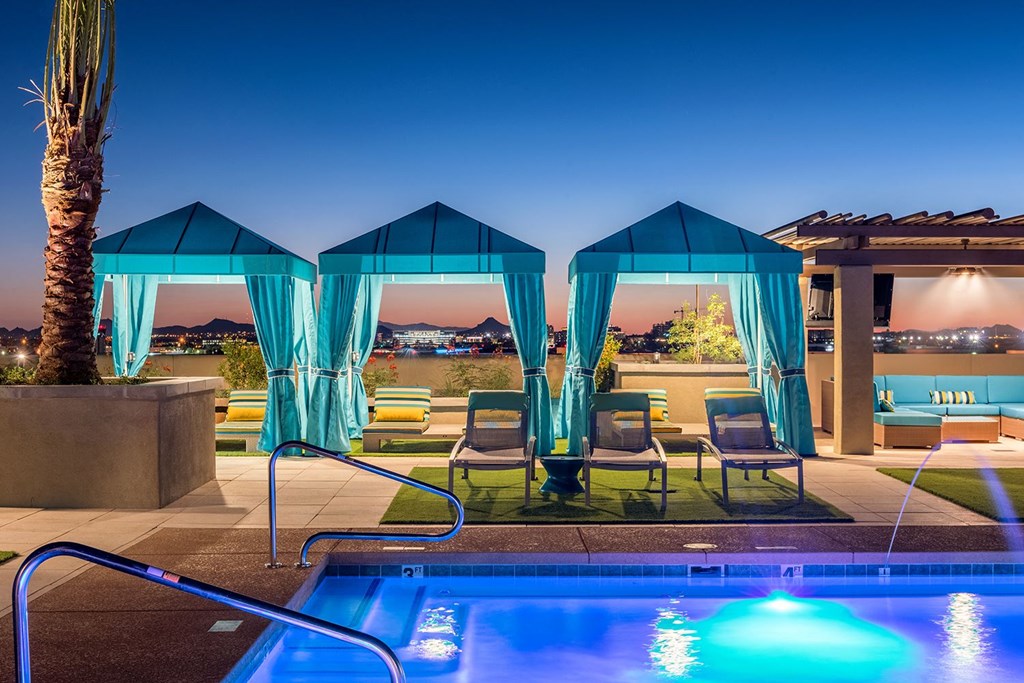 A poolside area with a view of the sunset.