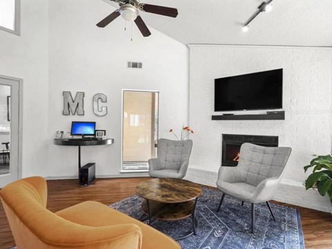 A living room with a yellow chair and a coffee table.