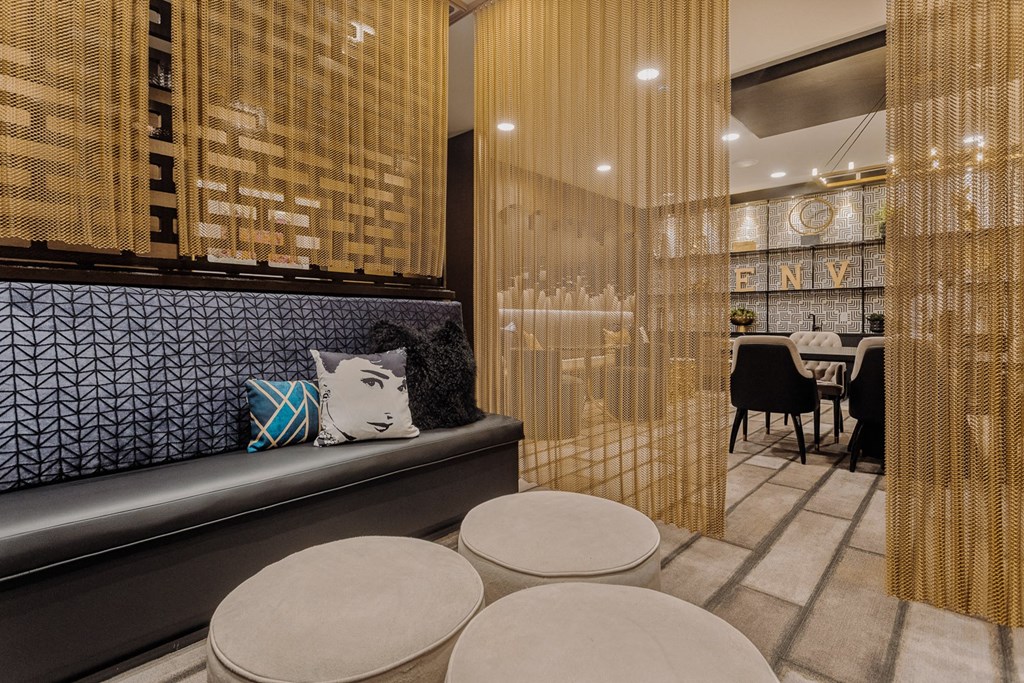 a seating area with a bench and four stools in a room with a table at The Hendry, Henderson, 89074