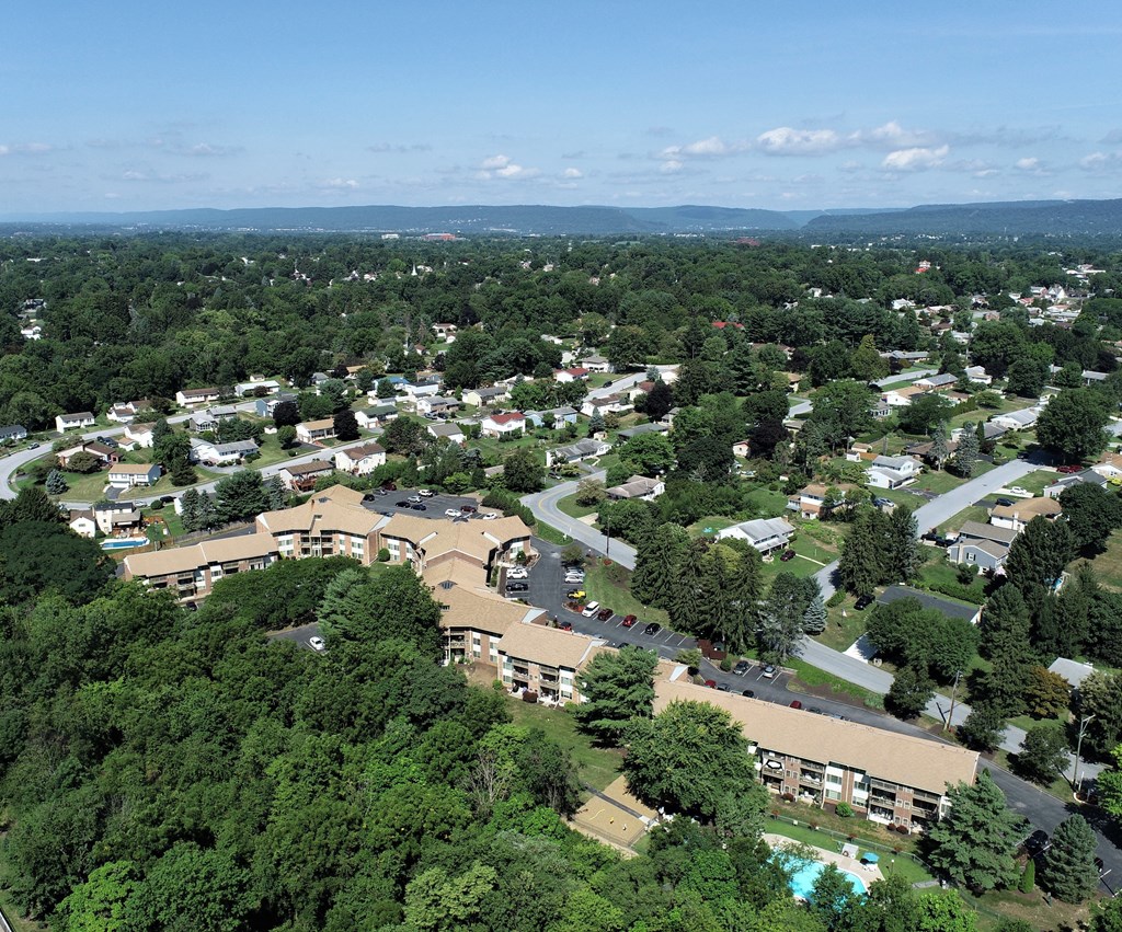 an aerial view of a city with trees and buildings
