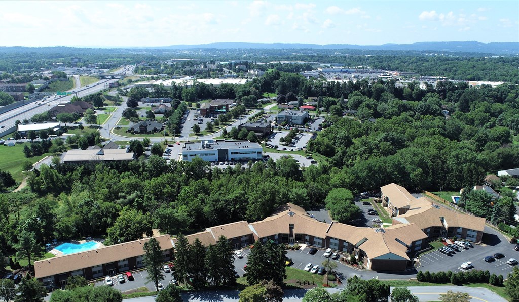 an aerial view of a city with trees and buildings