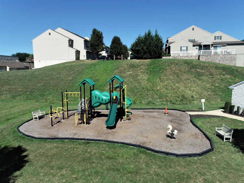 a playground in a yard with a green park