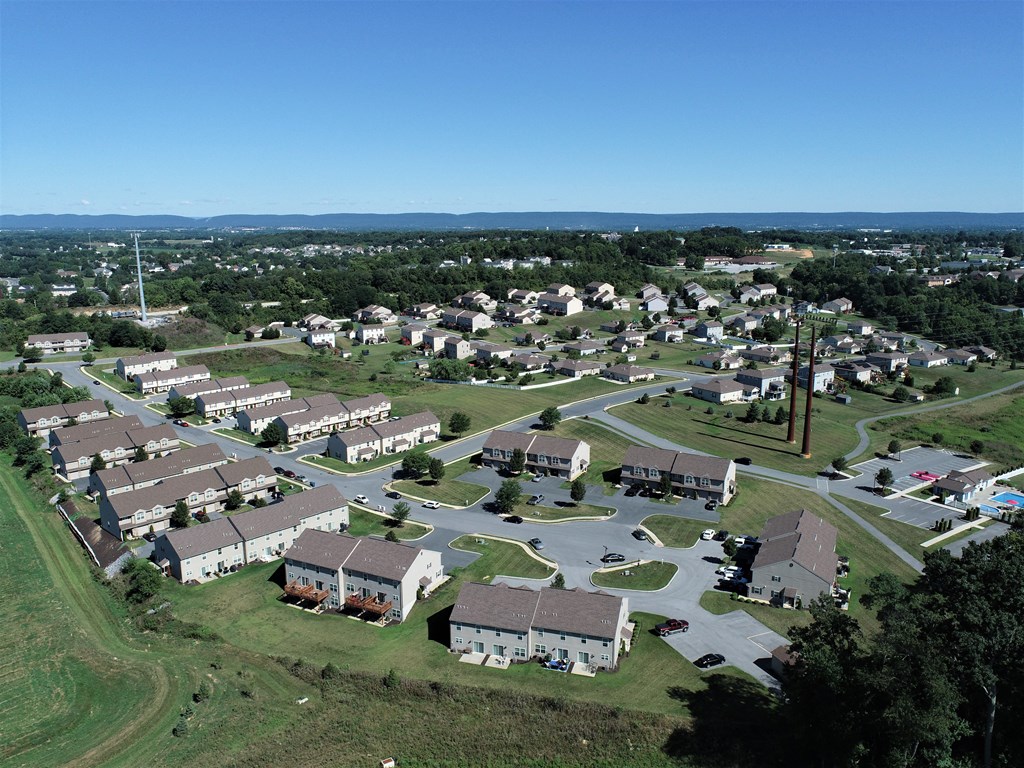 an aerial view of a suburban neighborhood with houses and cars
