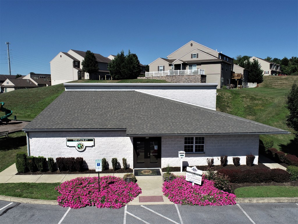 a white building with pink flowers in front of it
