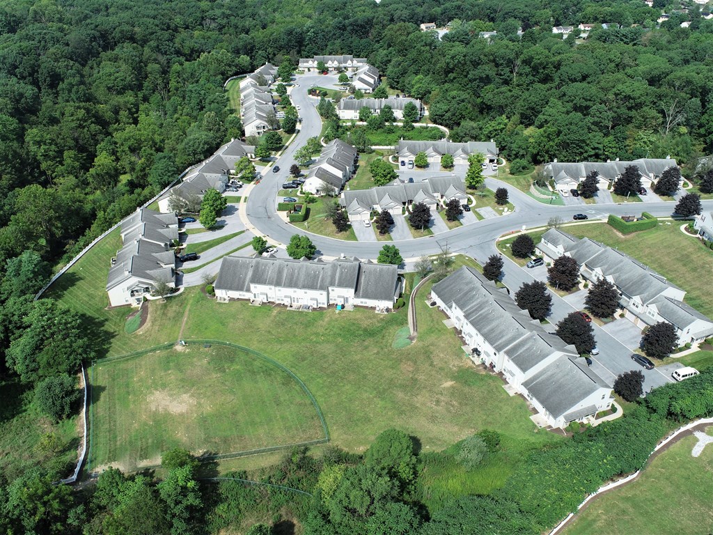 an aerial view of a community of buildings and trees