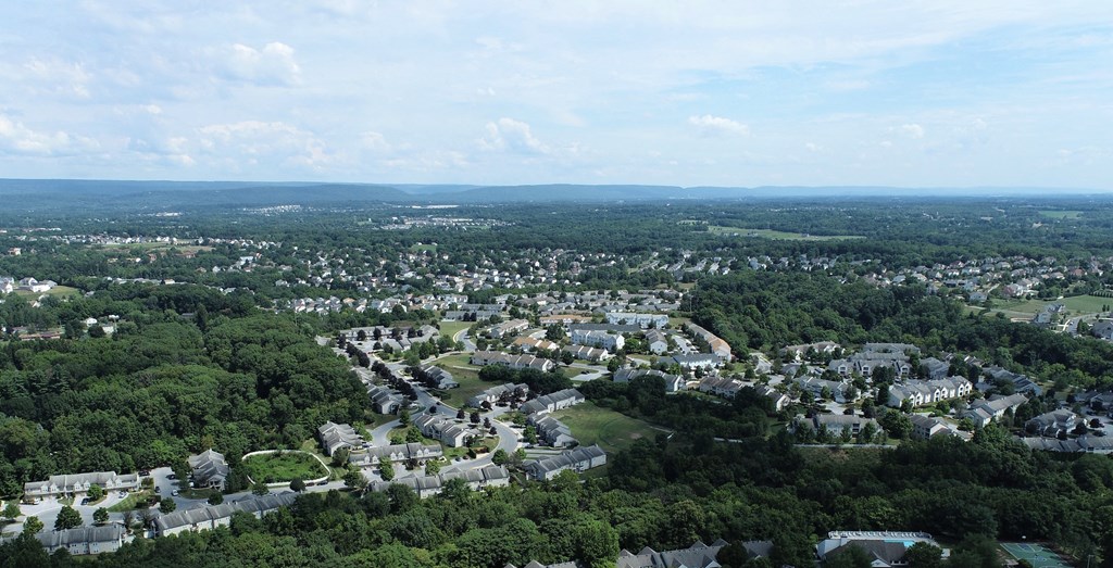an aerial view of a city with trees and buildings