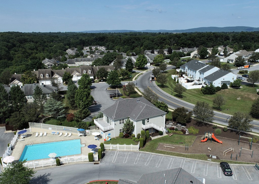 an aerial view of a neighborhood of houses and a swimming pool