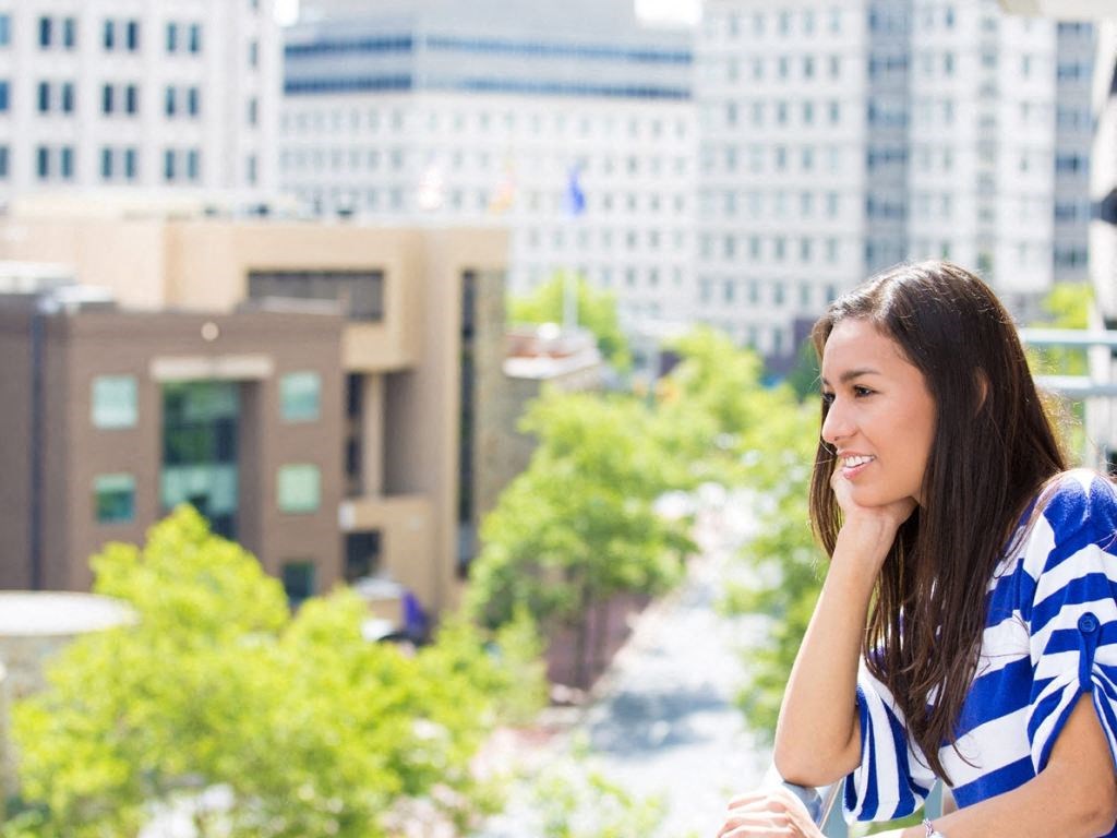 A resident enjoys the city views from the sky deck