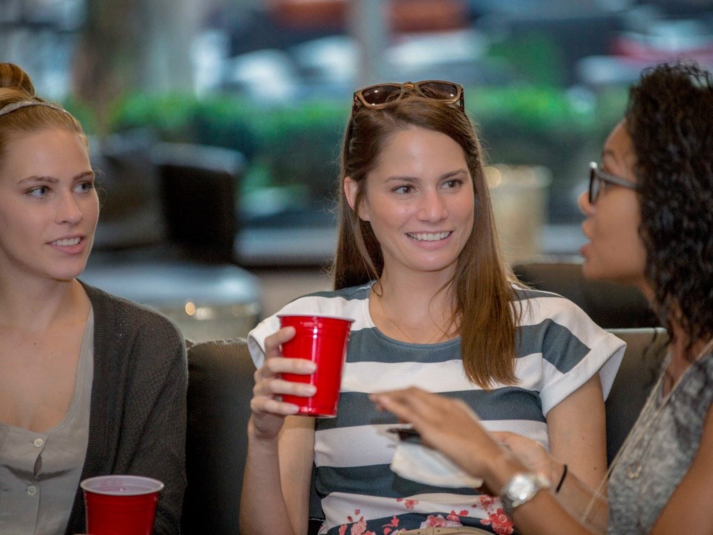 Three residents enjoy socializing over coffee