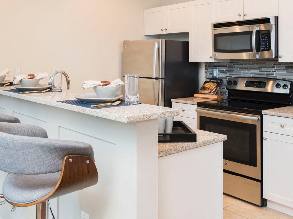 A breakfast bar with granite countertops