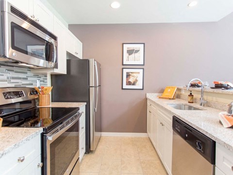 a kitchen with stainless steel appliances and granite counter tops