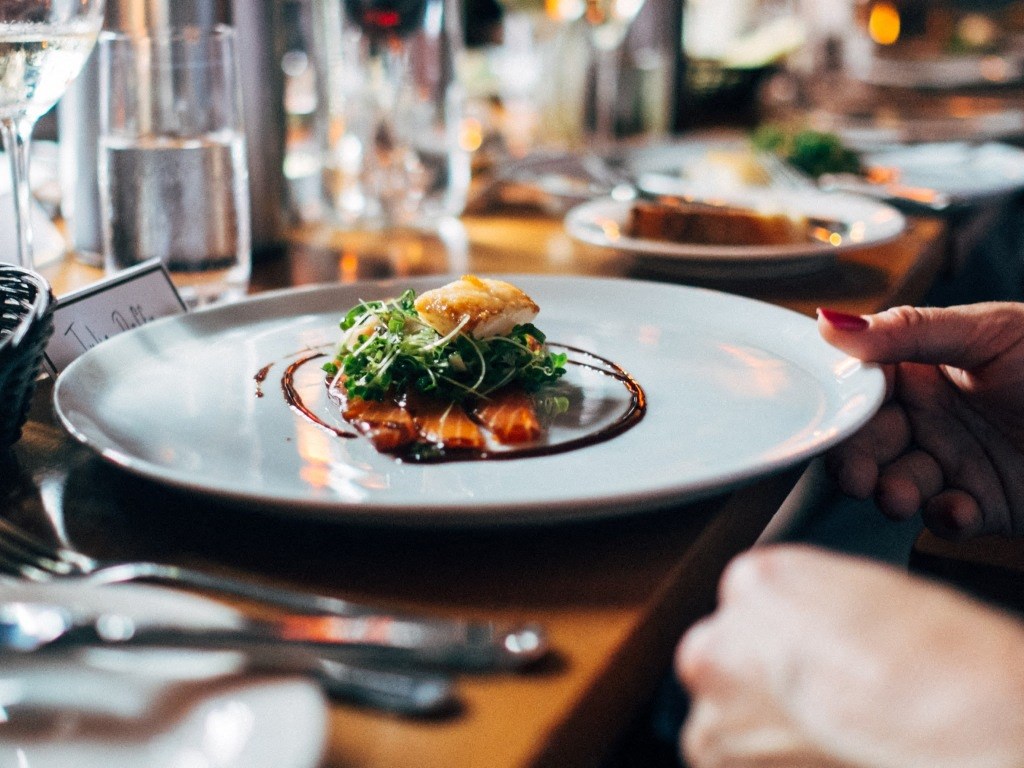 A woman dines on a gourmet meal.