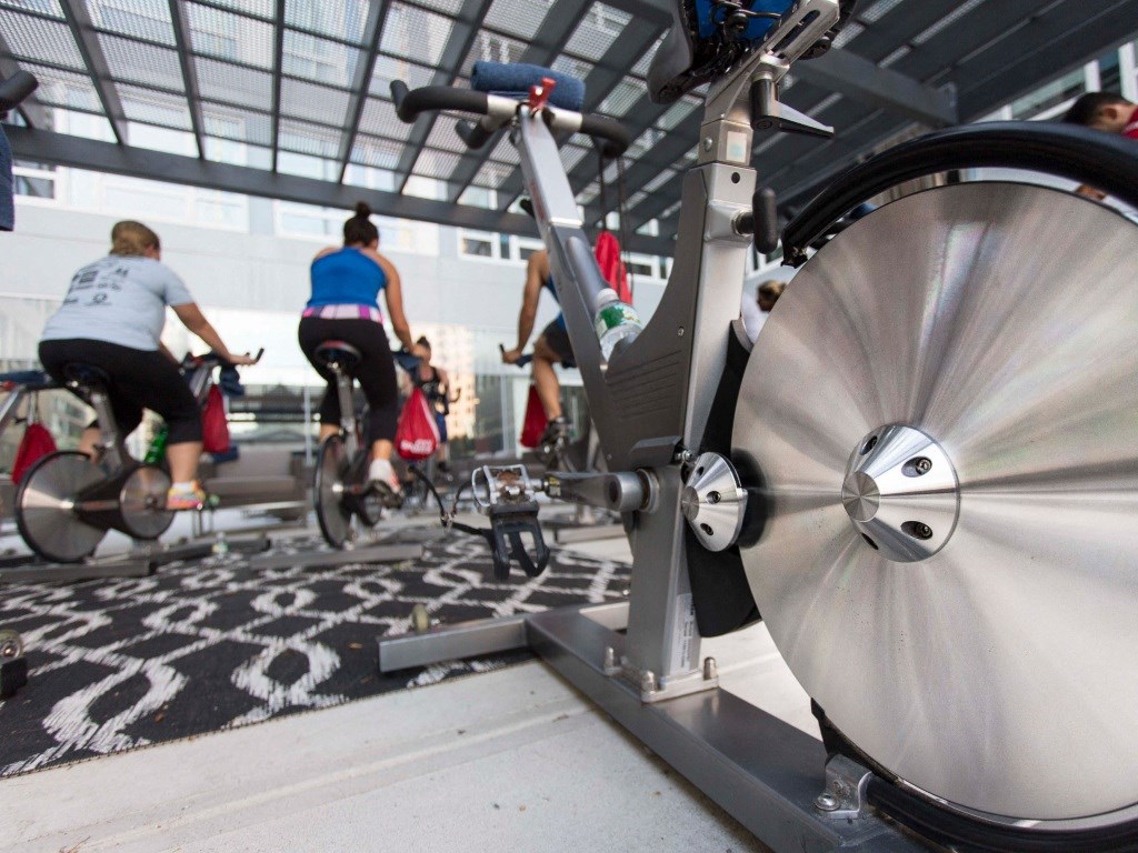 Residents use cardio equipment in the gym