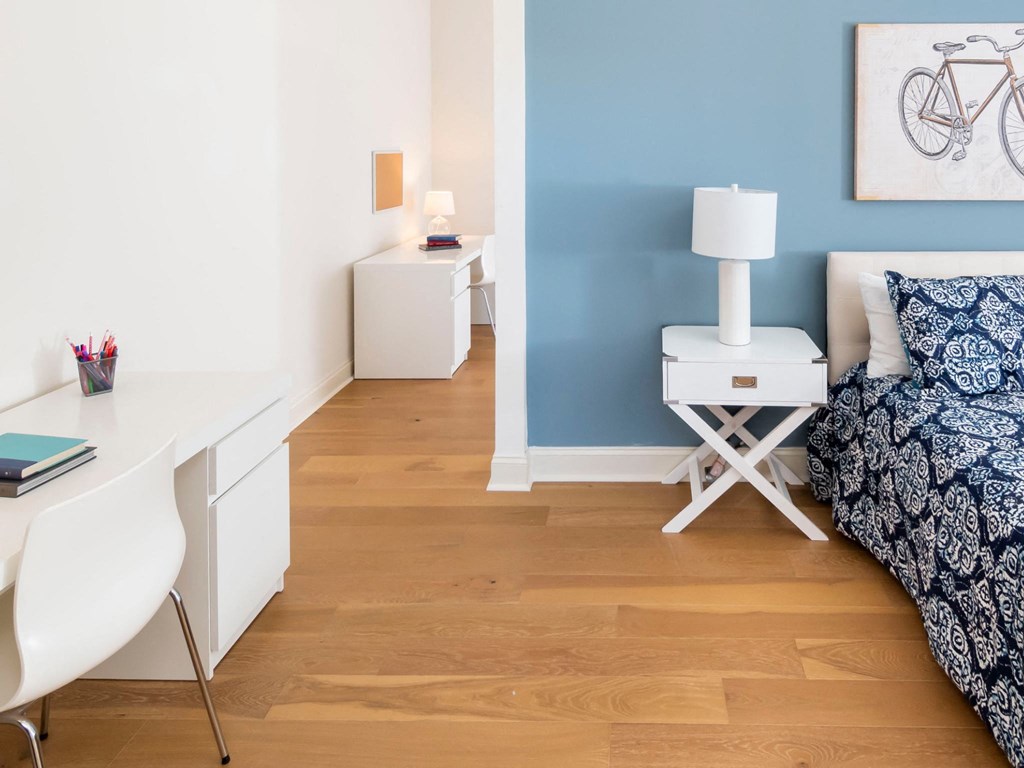 A Kardon Atlantic bedroom features hardwood flooring