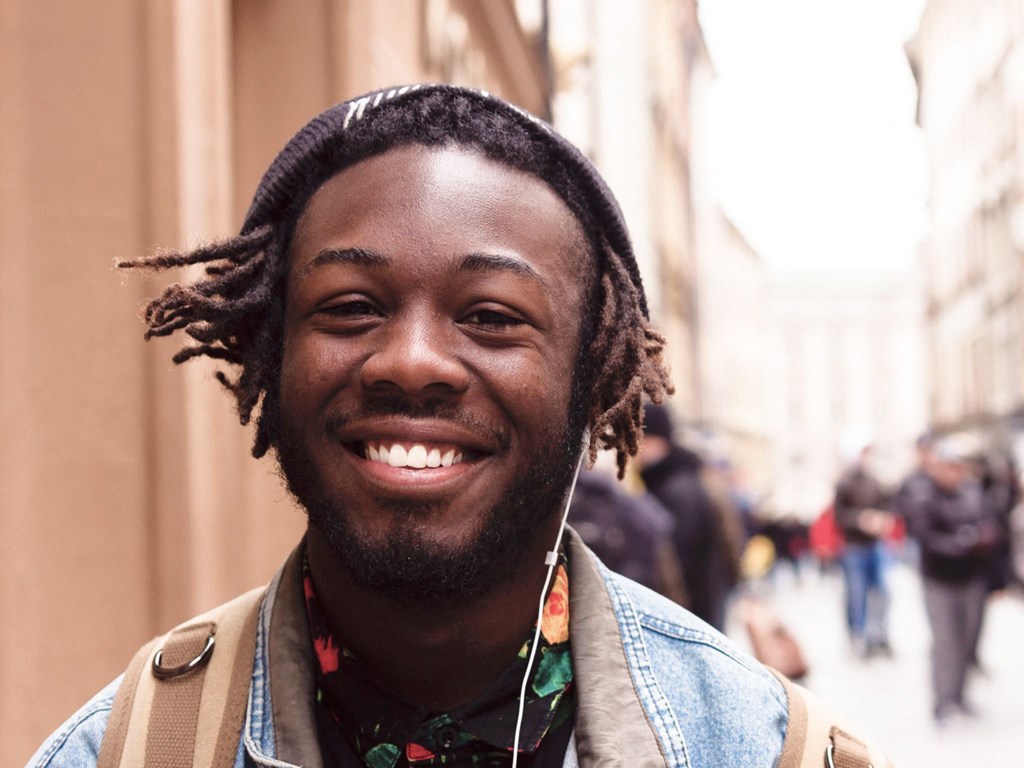 A Kardon Atlantic resident walks to class listening to headphones