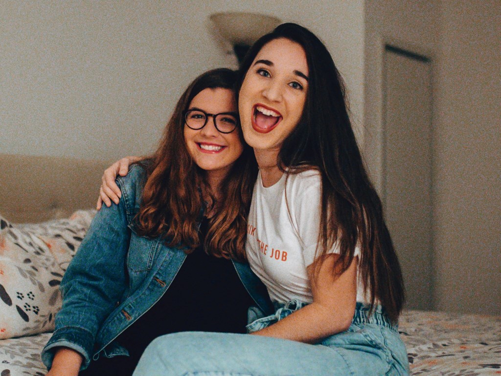 Two Kardon Atlantic residents laughing in their apartment bedroom