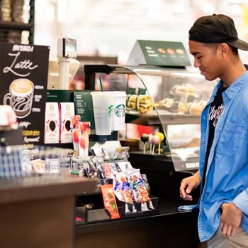 a young man reviews the items at a Starbucks checkout