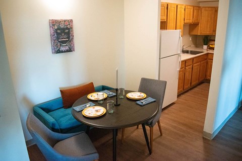 a dining room with a table and chairs and a kitchen