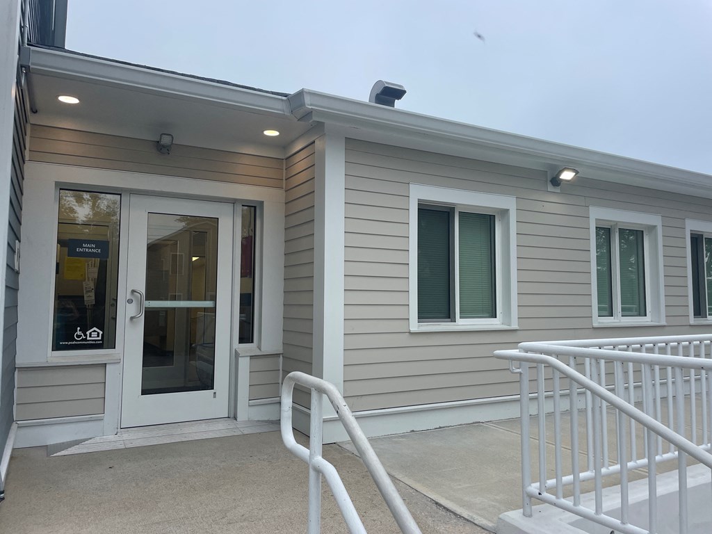 a home with a front door and a ramp to a porch