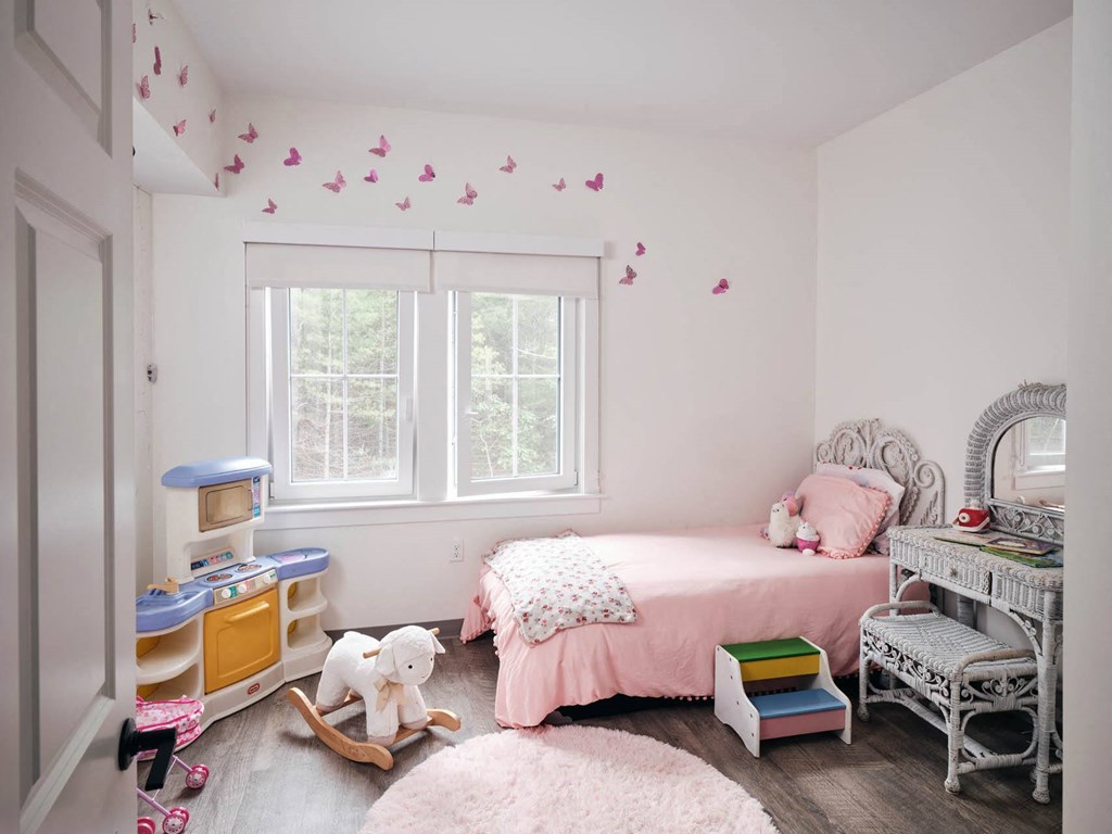 a bedroom with a bed and a desk