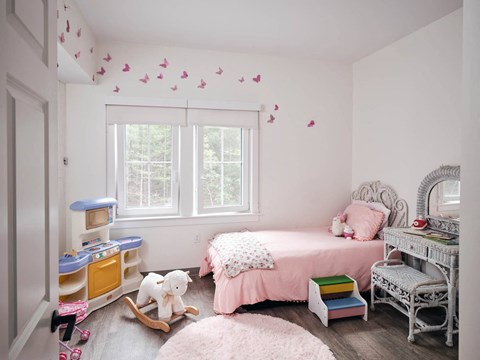 a bedroom with a bed and a desk