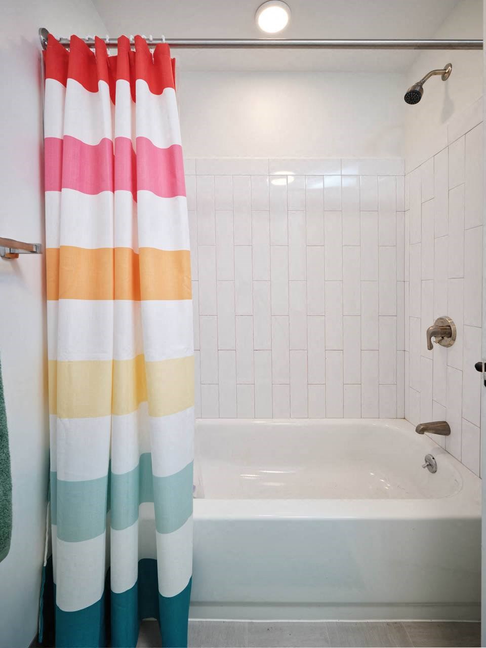 a bathroom with a bathtub and a shower curtain