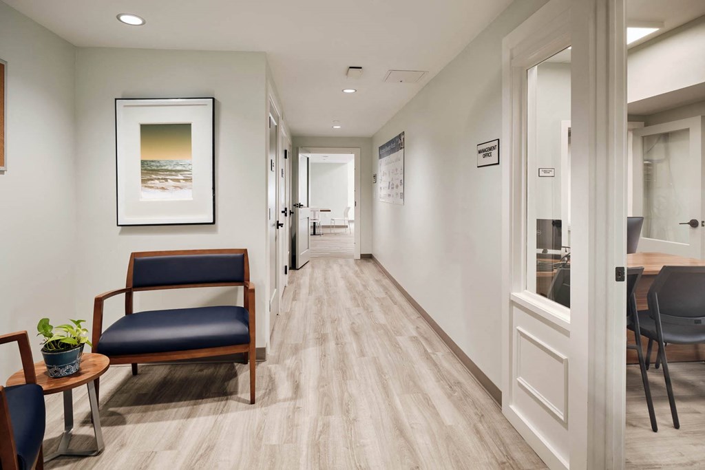 a corridor with a chair and a table