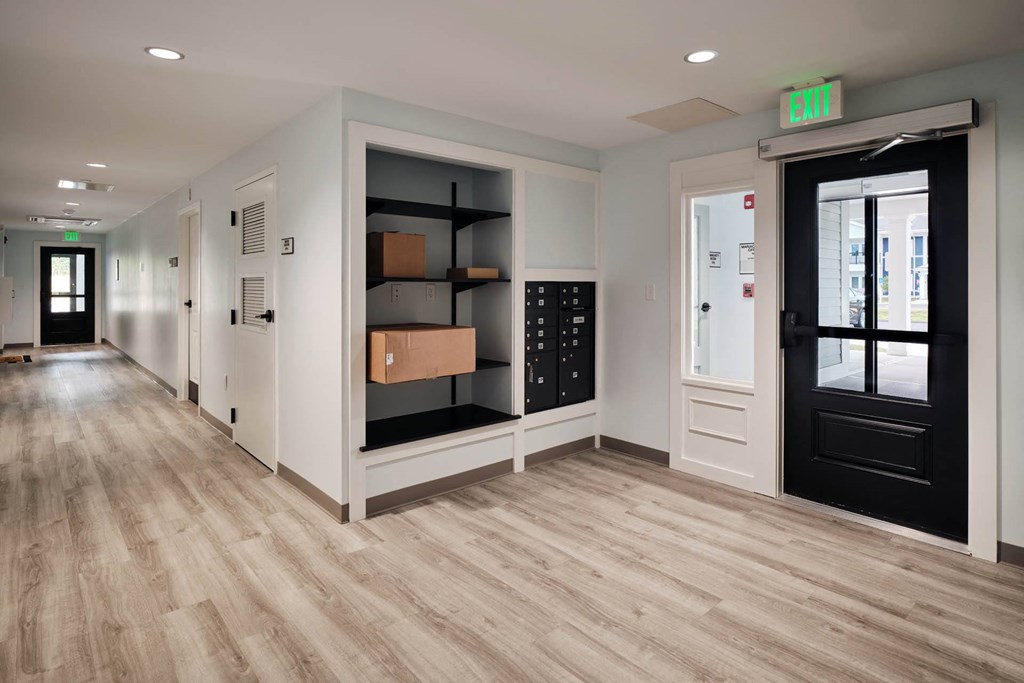 a room with a black door and a wooden floor