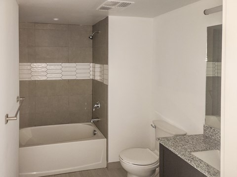 a bathroom with a toilet and a tub and a sink