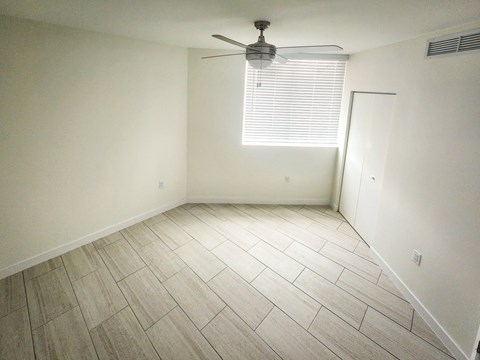 an empty room with a ceiling fan and a window at Meridian Point at Goulds Station in Miami, FL, 33170