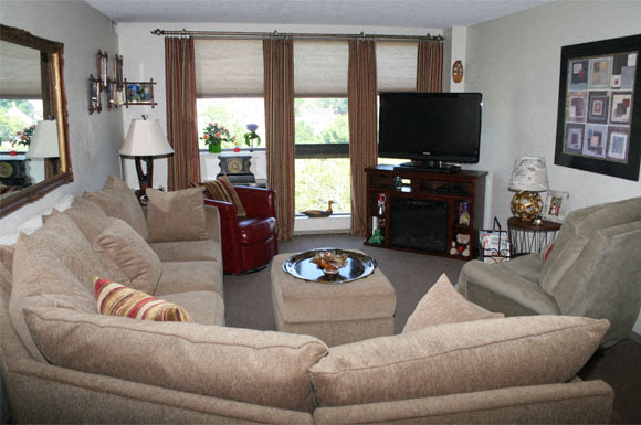 A living room with a large couch and a television.