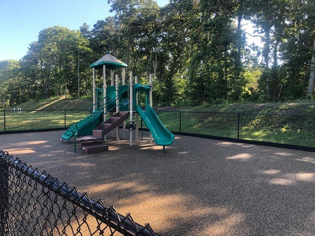 a playground with a slide in a park