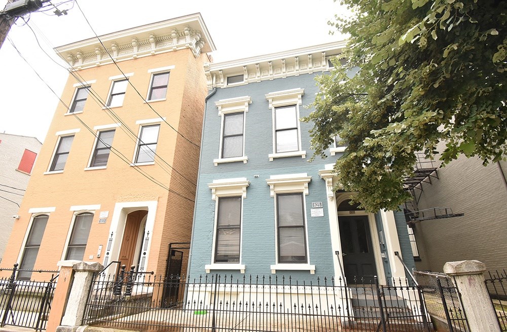 a blue house and a yellow house are next to each other