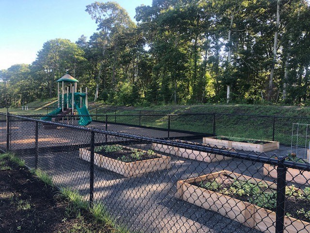 a fenced in area with a playground in the background