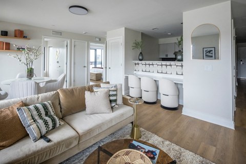 A living room with a beige couch and a coffee table.