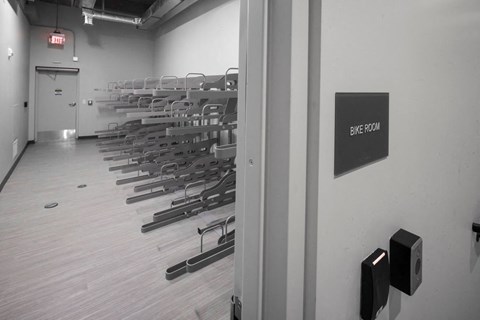 A bike room with a sign on the wall.