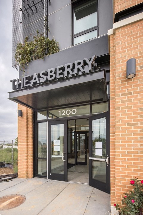 The entrance to The Asberry building with a sign above the door.