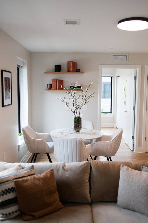 a living room with a table and chairs and a couch