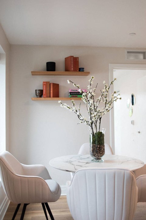 Dining room table with decor on the wall above