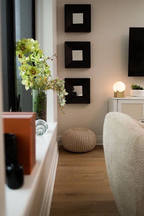 a small living room with a couch and a window