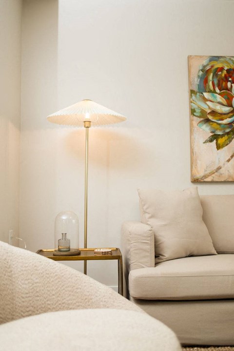 a living room with a couch and a lamp