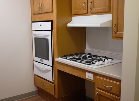 a kitchen with a stove top oven and a sink