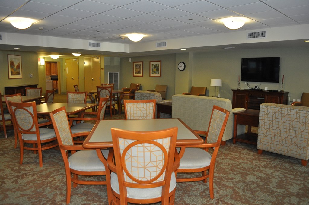 a dining room with tables and chairs and a tv