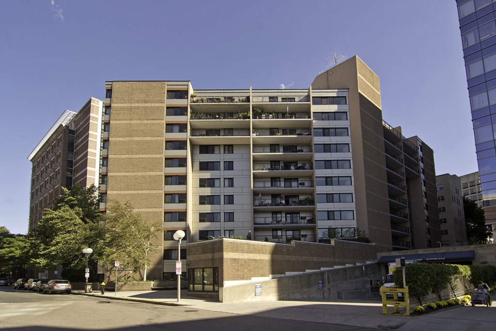 an apartment building on the corner of a city street