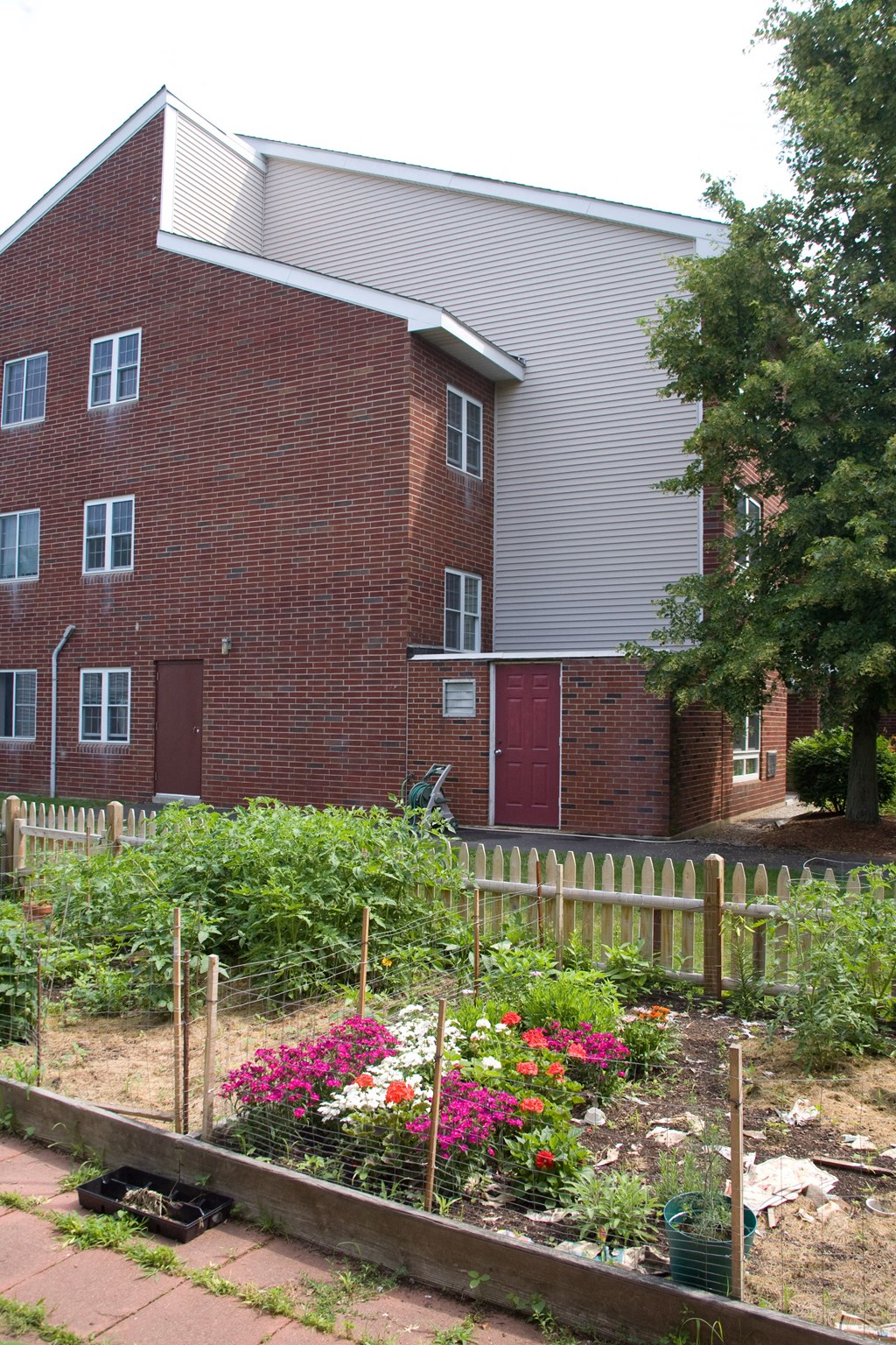 a garden in front of a brick building