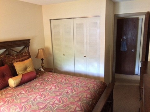 a bedroom with a large bed and a closet