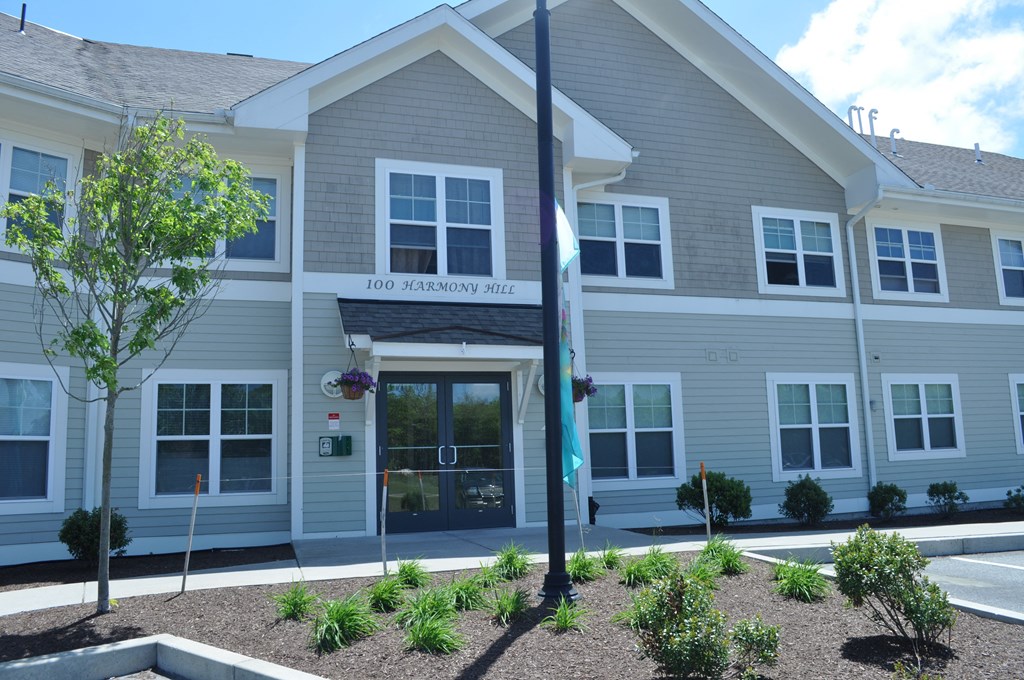the front of a white building with a sign on it
