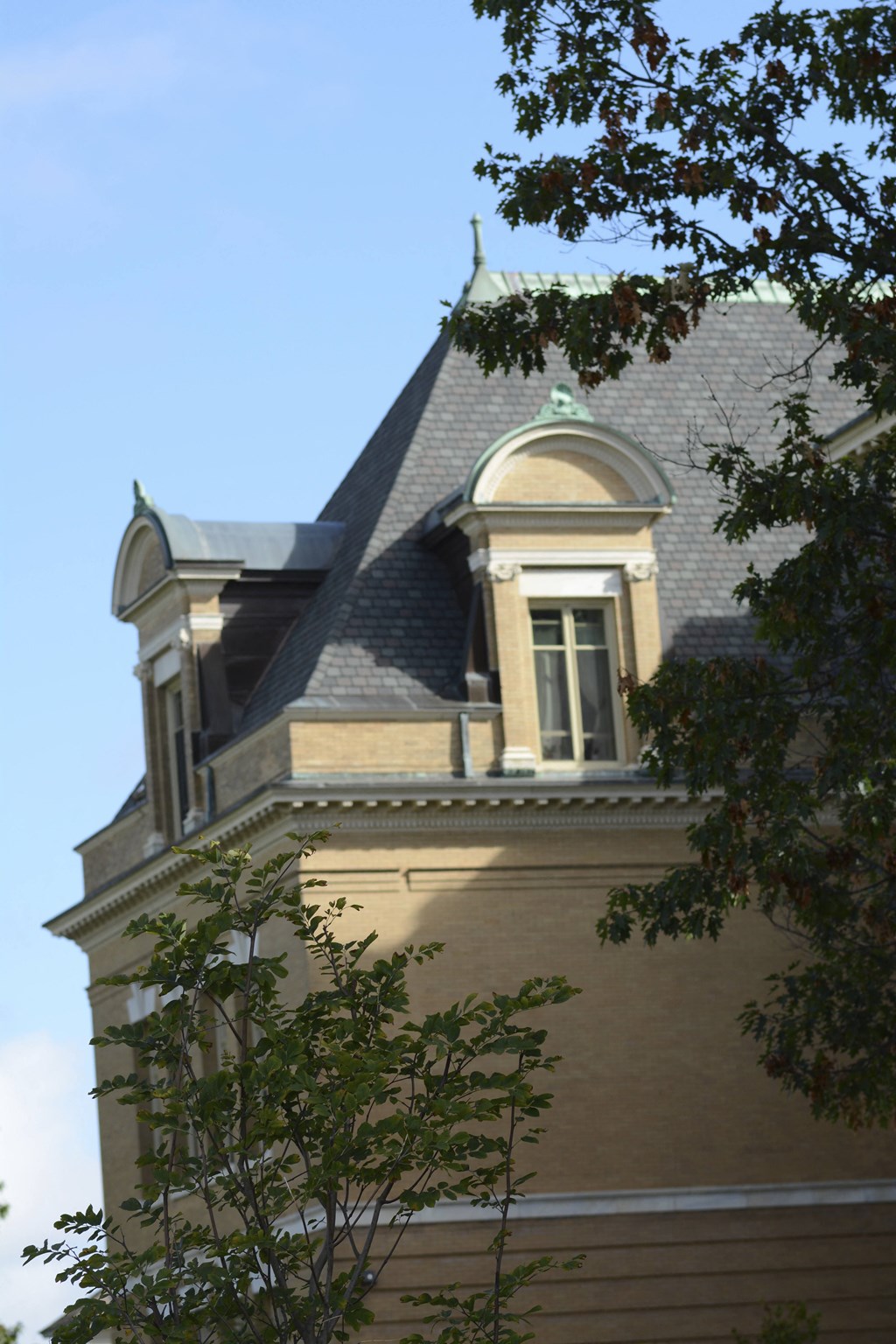 the top of a building with two windows and a roof
